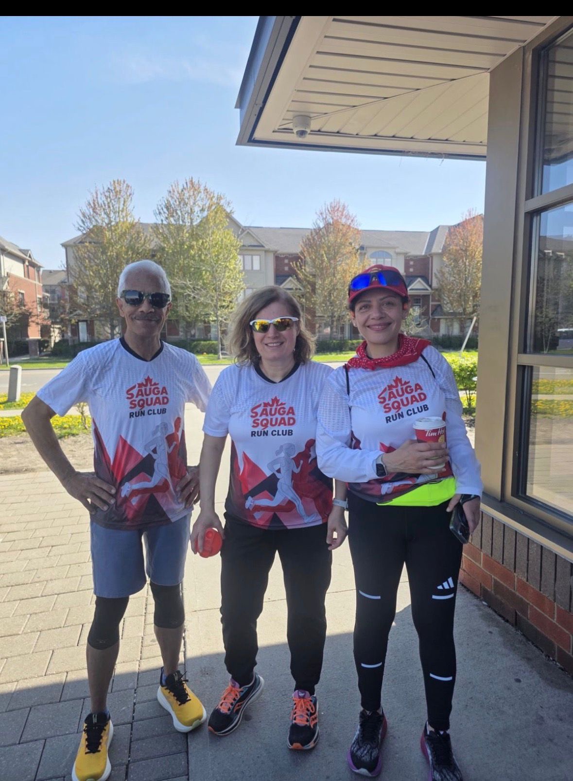 Three runners wearing the Sauga Squad jerseys
